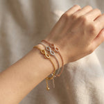 Infinity bracelet worn on wrist with fine chain and infinity symbol detail