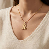 Woman wearing Initial Necklace with letter pendant, personalised jewellery lifestyle image