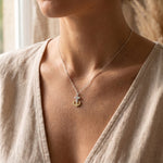 Woman wearing keep me grounded necklace, anchor pendant symbolising strength and emotional support