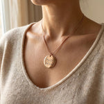 Woman wearing kids drawing necklace with custom engraved artwork on pendant