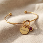 Knot bangle with personalised charm option, symbolic bracelet with engraved disc and birthstone detail