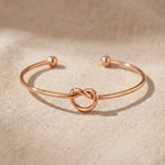 Knot bangle in rose gold with symbolic knot design, elegant meaningful jewellery keepsake gift