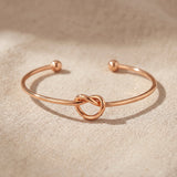Knot bangle in rose gold with symbolic knot design, elegant meaningful jewellery keepsake gift