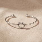 Knot bangle in silver with symbolic knot design, elegant open cuff bracelet gift for her