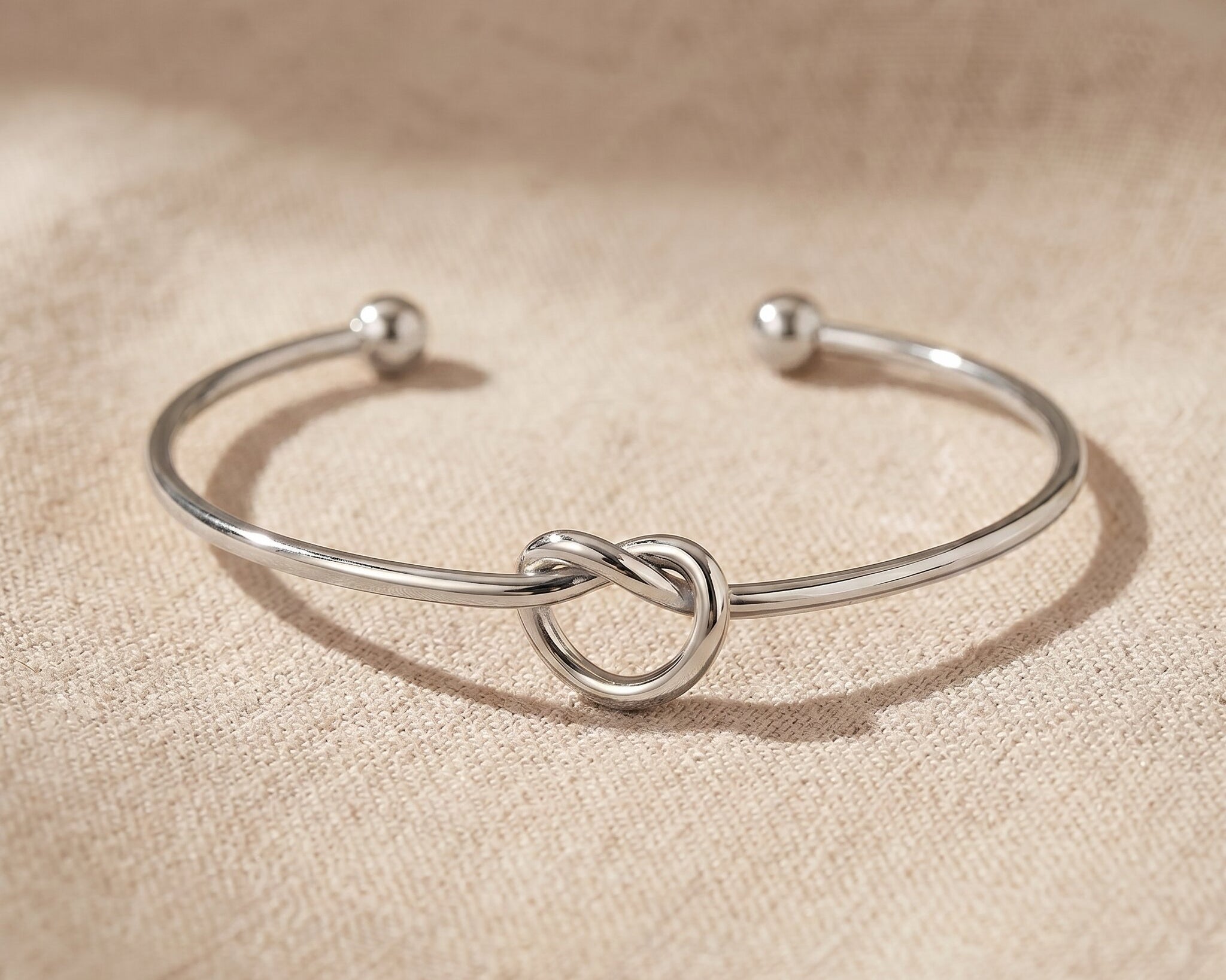 Knot bangle in silver with symbolic knot design, elegant open cuff bracelet gift for her