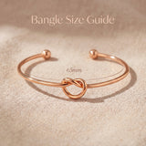 Knot bangle size guide showing open cuff bracelet dimensions and symbolic knot detail proportions