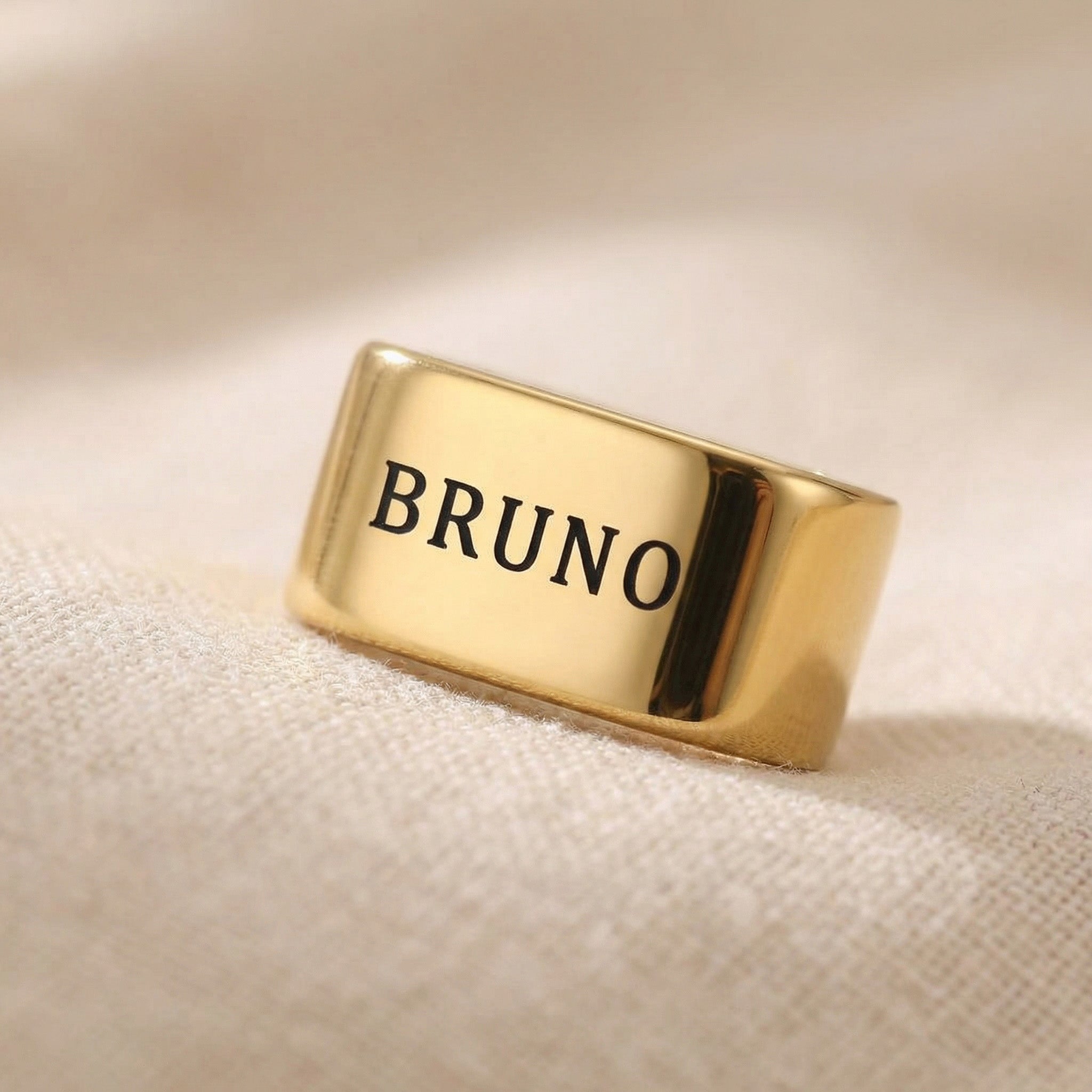 Gold Leather Bracelet Charms with name engraved displayed on neutral background