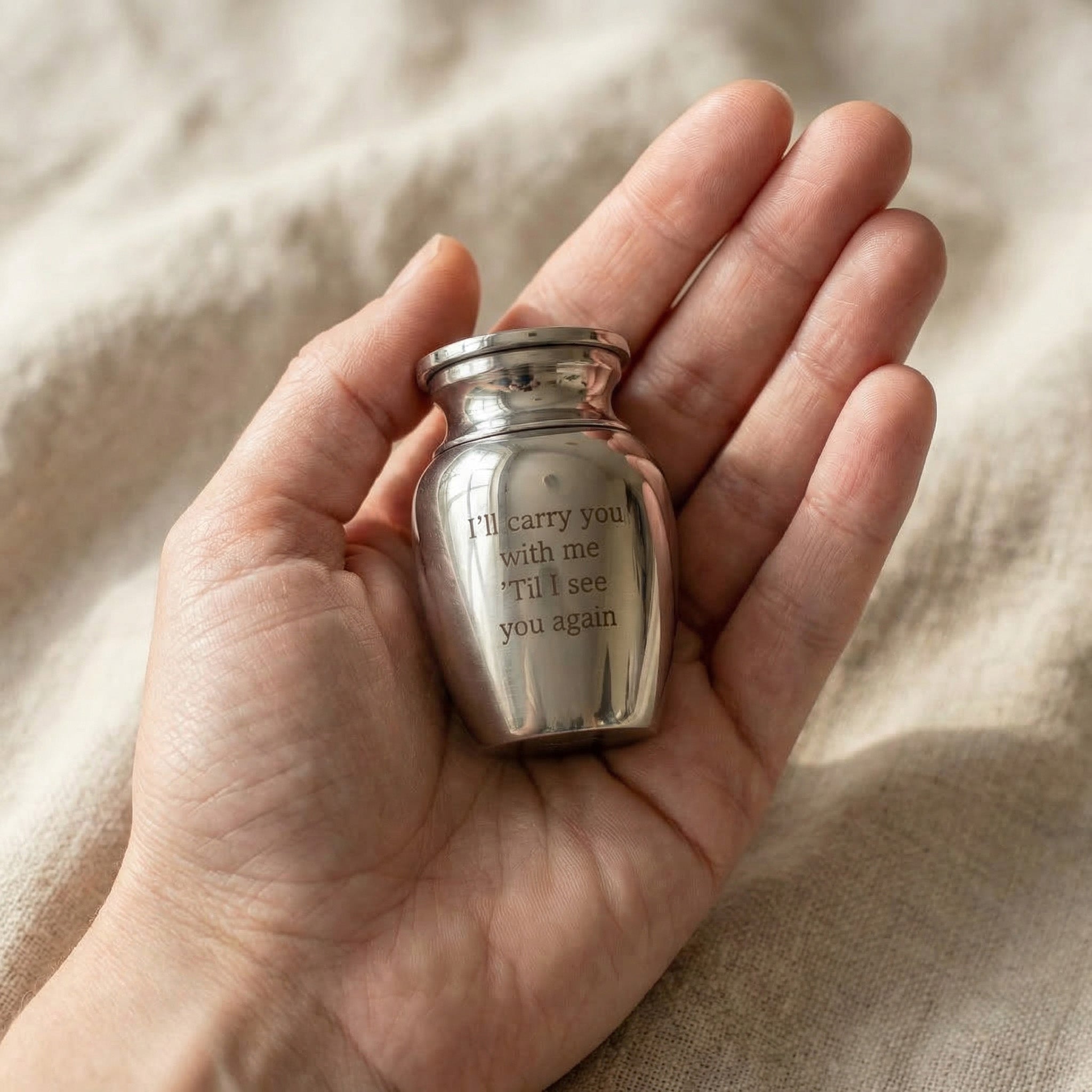 Hand holding Mini Personalised Keepsake Urn, small memorial urn for ashes keepsake