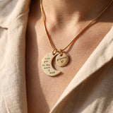 Woman wearing moon and back necklace, symbolic jewellery celebrating love, connection and family bond