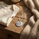 Belle Fever mother’s disc necklace editorial flatlay, family name necklace, Mother’s Day gift keepsake