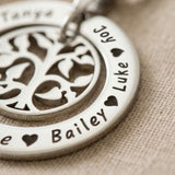 Close up of My Family Tree necklace showing engraved name pendant with circular tree insert detail