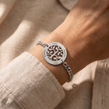 Woman wearing tree of life bracelet, symbolic family jewellery representing growth, strength and connection