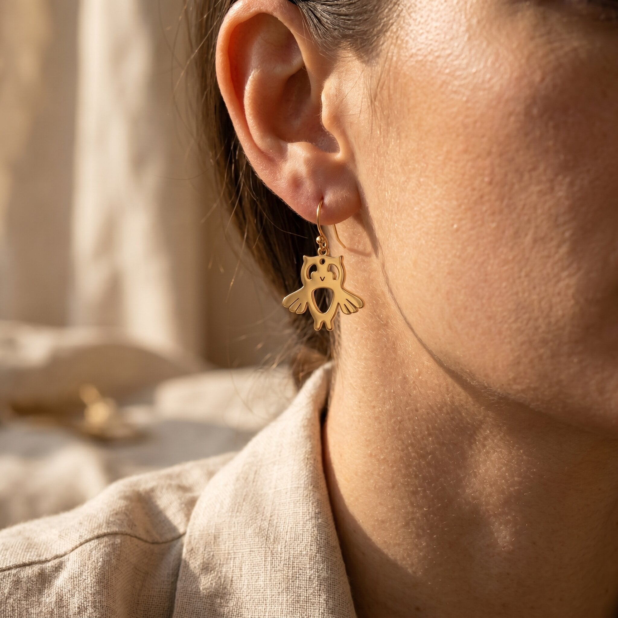 Woman wearing owl earrings, delicate animal-inspired jewellery for everyday style and meaningful gift