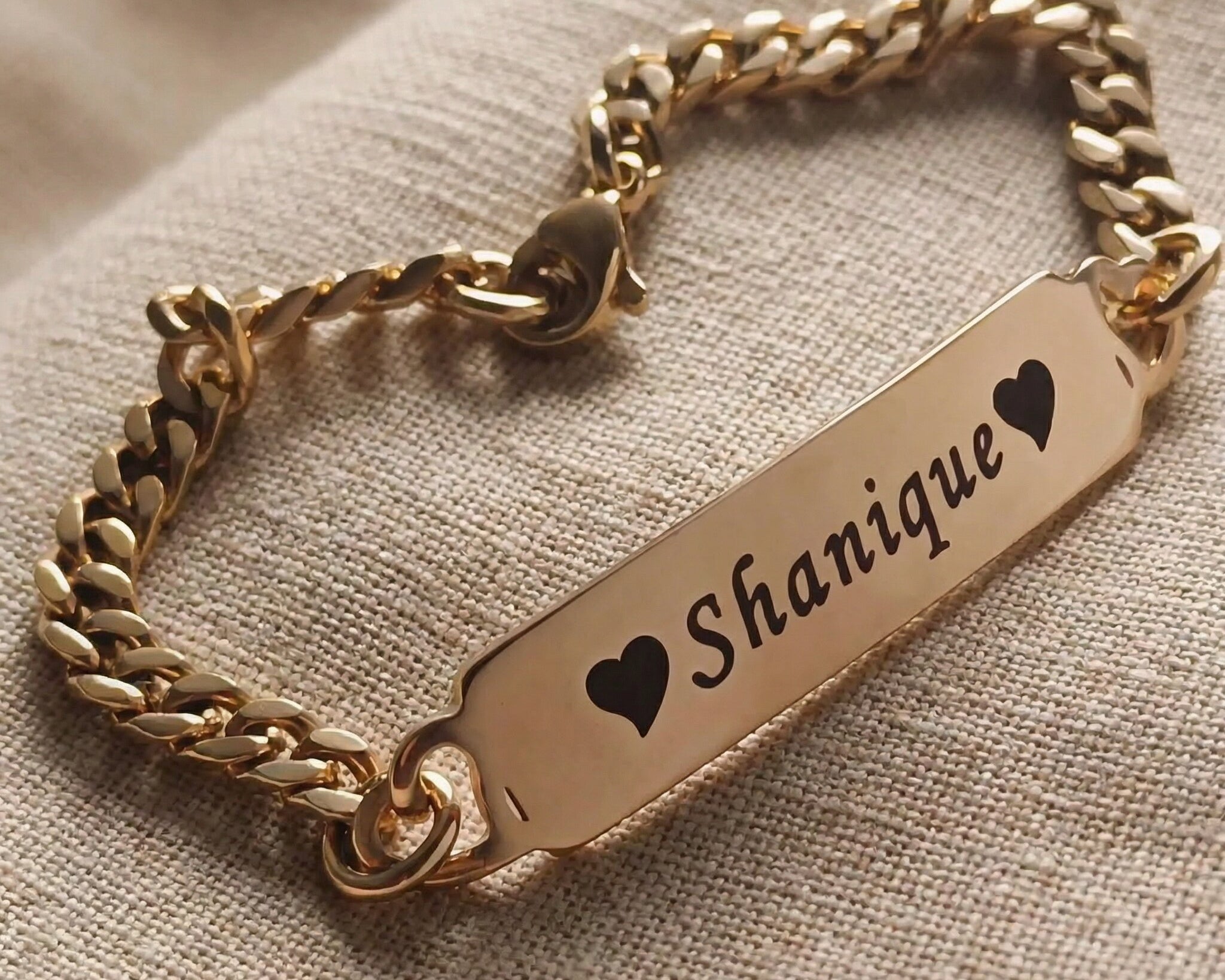 Personalised bracelet with heart accent and engraved name plate, sentimental jewellery design