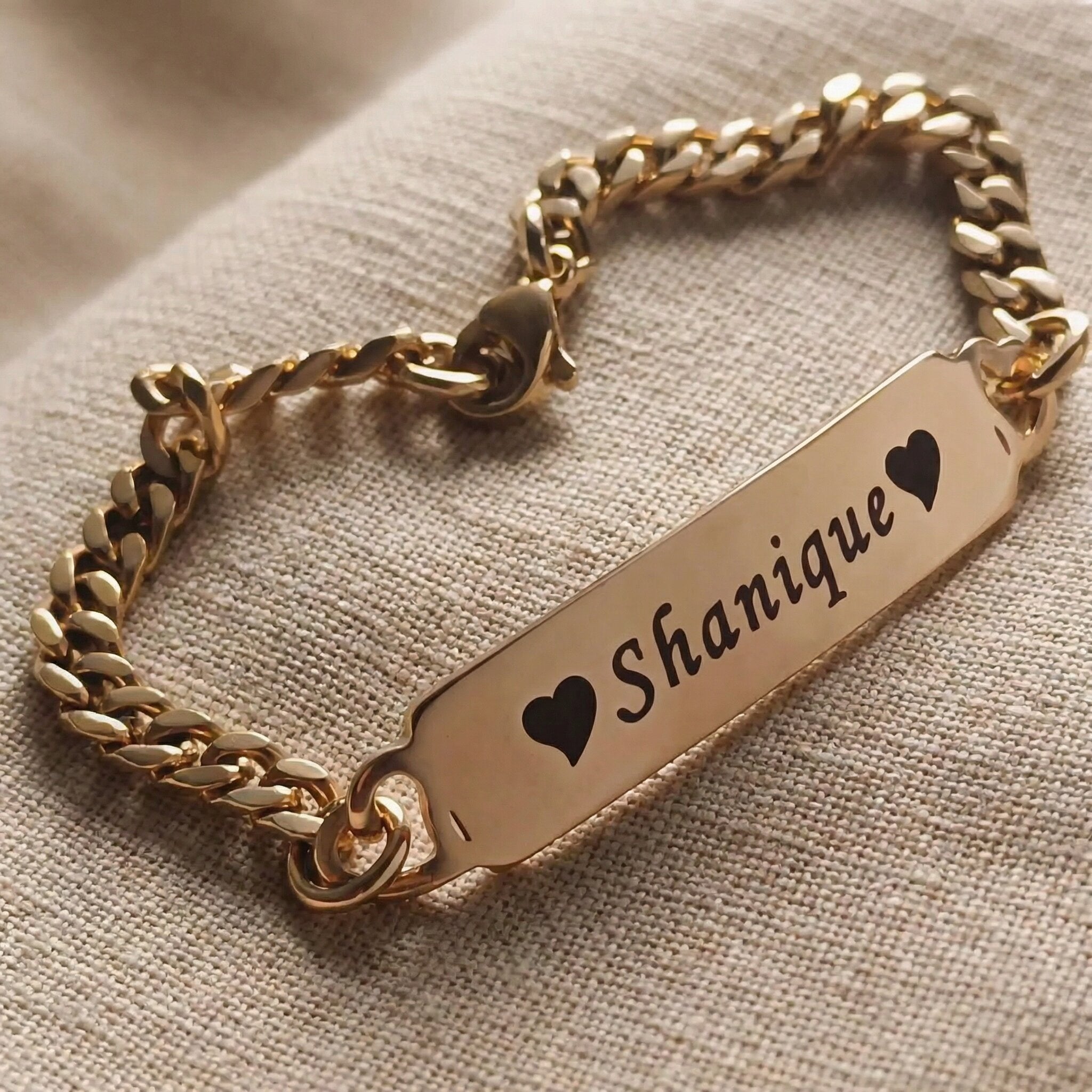 Personalised bracelet with heart accent and engraved name plate, sentimental jewellery design