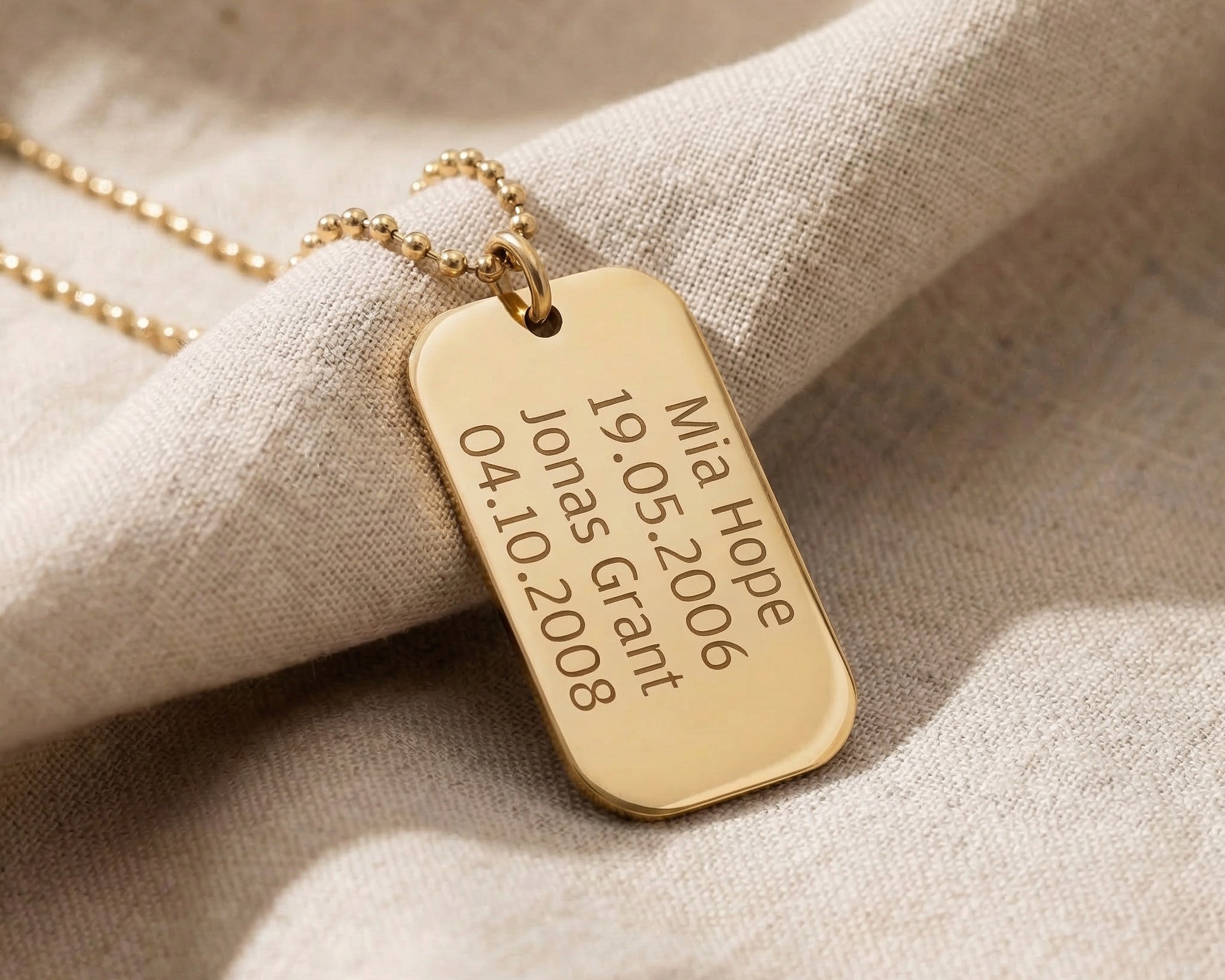 Personalised dog tag necklace in gold with engraved message, classic custom jewelry piece