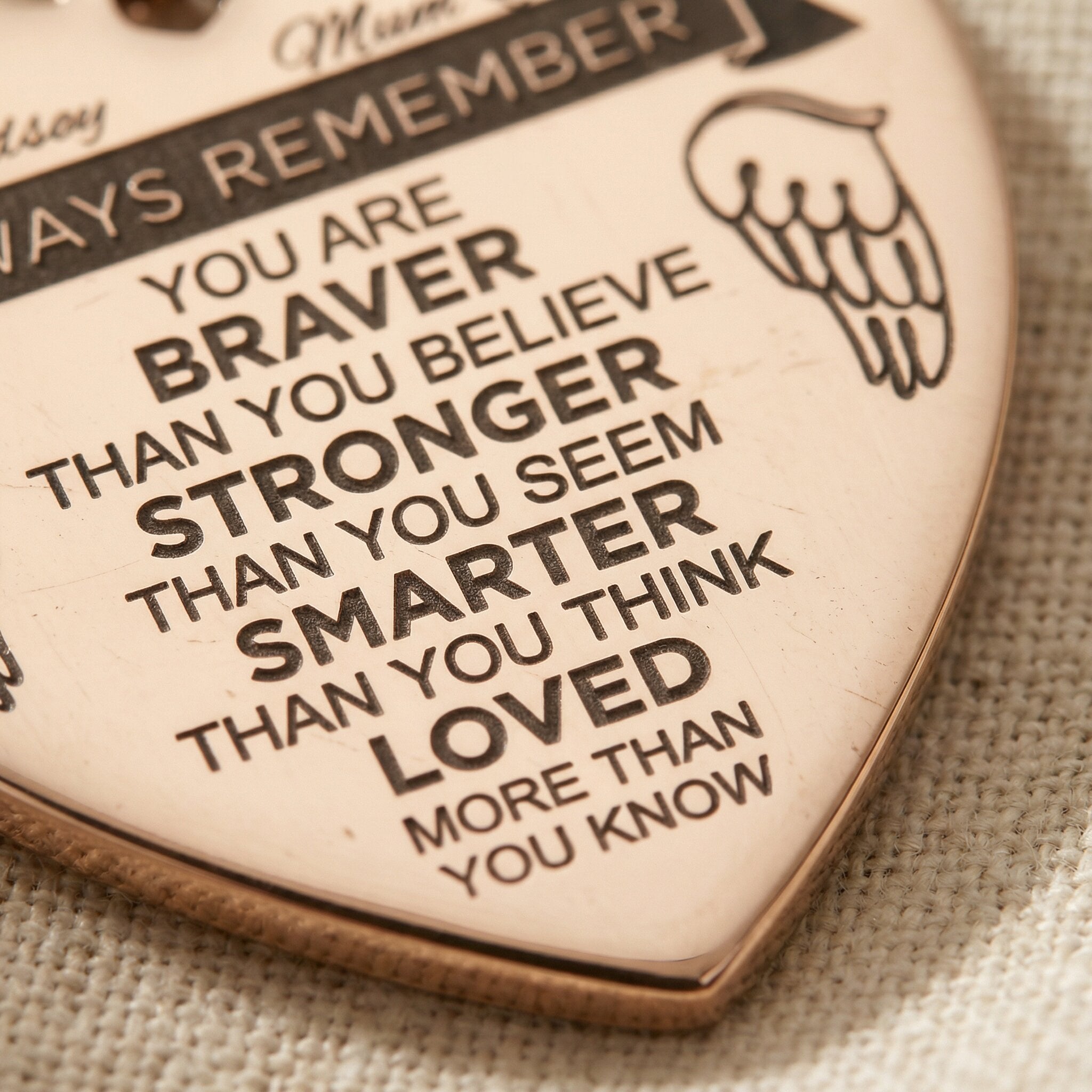 Close-up of personalised heart necklace with engraved message and detailed text design