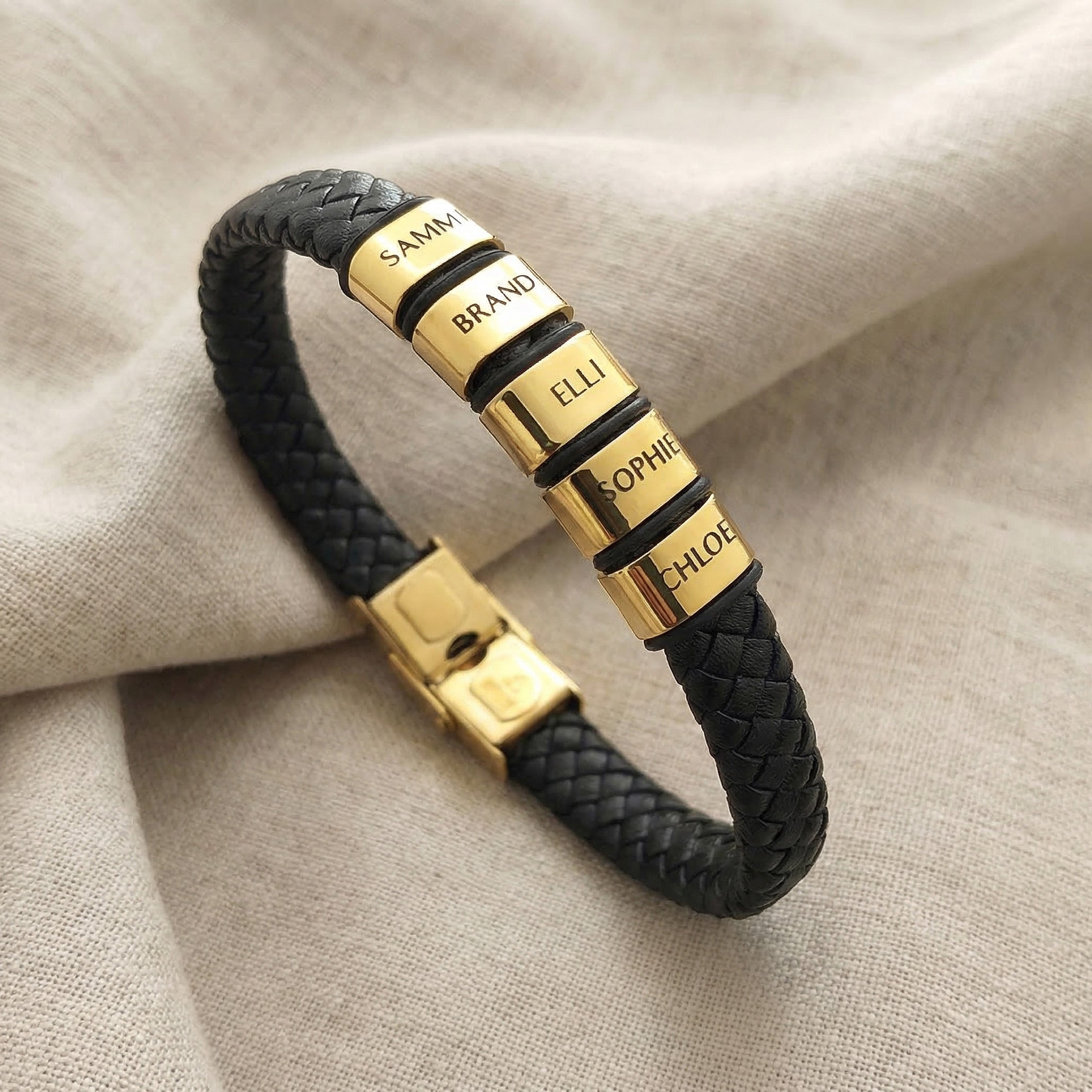 Personalised black leather bracelet with multiple engraved name charms showing customisation option