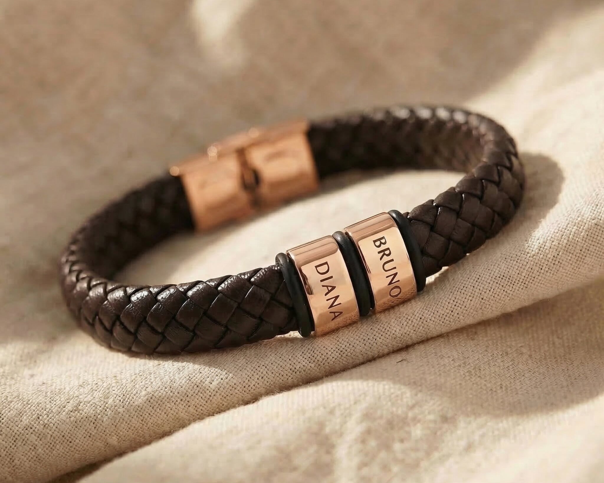 Personalised leather bracelet with rose gold engraved name charms, bold and meaningful design