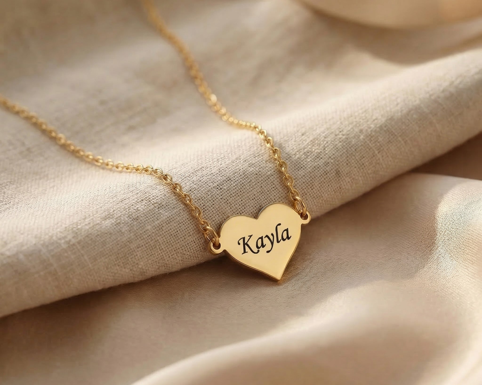 Personalised heart necklace in gold with engraved name detail
