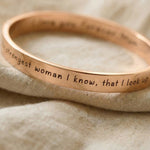 Close-up of personalised promise bangle with engraved message detail