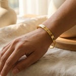 Woman wearing personalised promise bangle with engraved message, everyday jewellery style