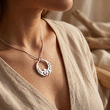 Woman wearing queen of my heart necklace, meaningful mother jewellery symbolising love and family connection