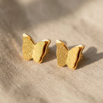 Sparkling butterfly earrings in gold with textured detail, symbolic jewellery gift for her
