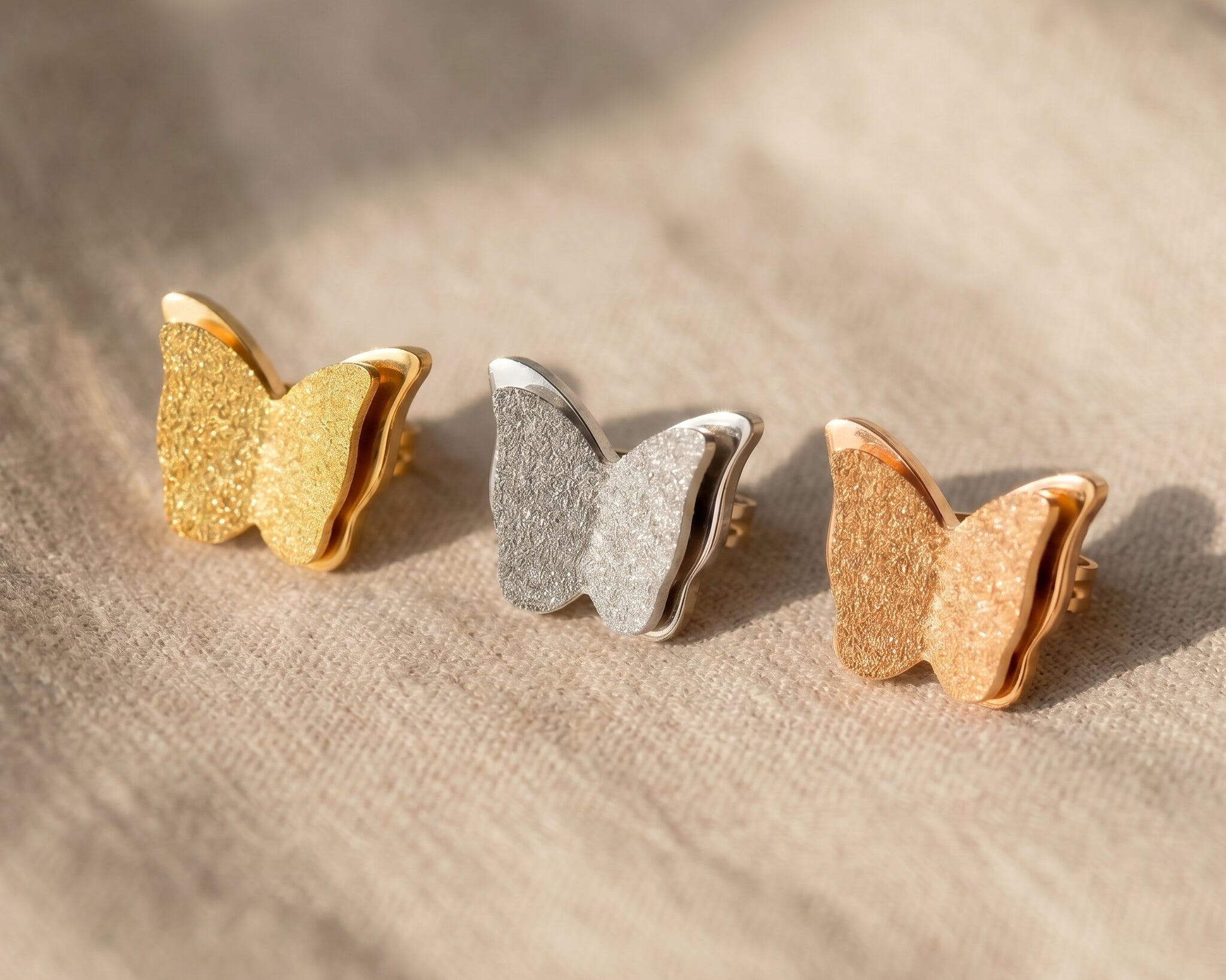 Sparkling butterfly earrings tone comparison showing gold, silver and rose gold elegant jewellery options