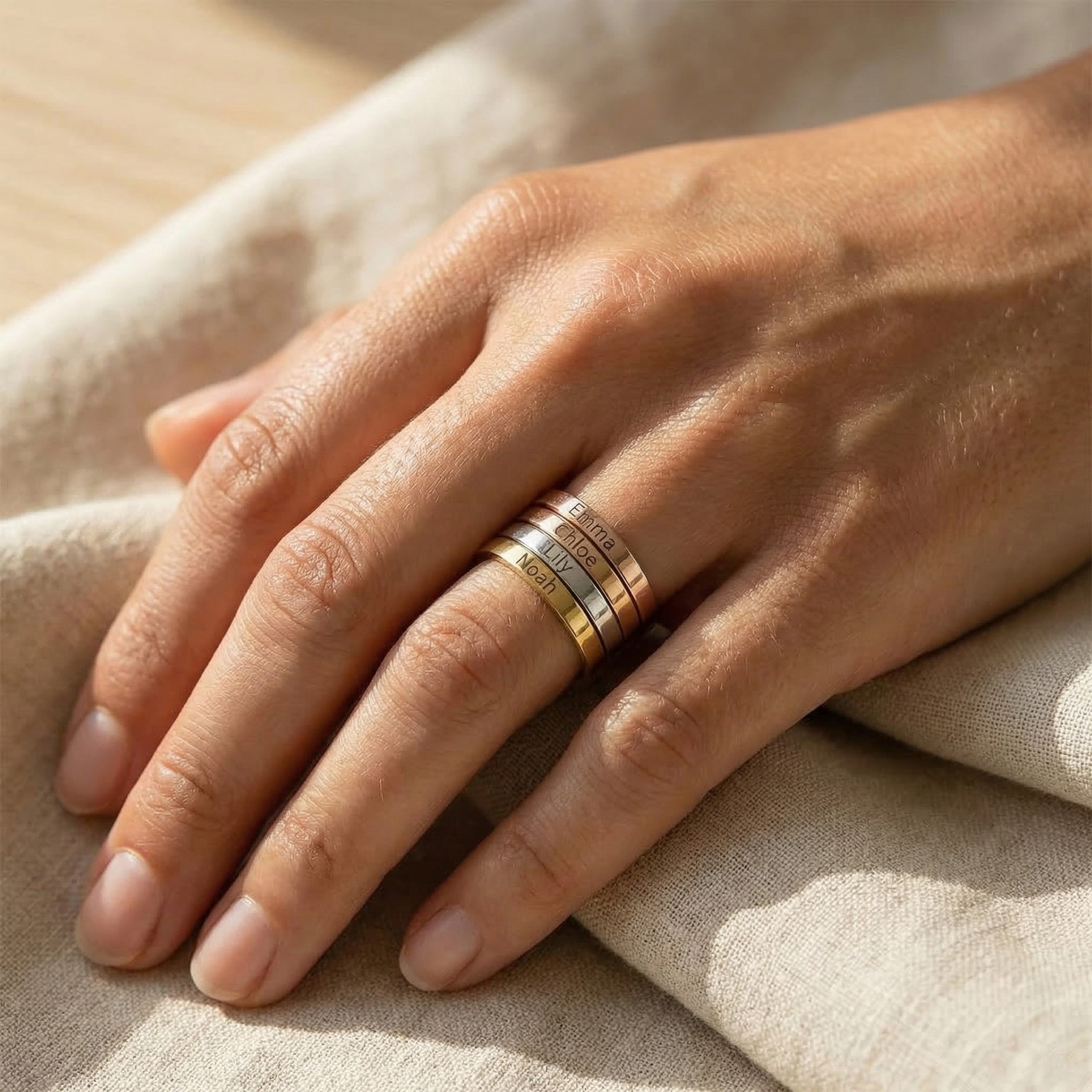 Woman wearing personalised stackable ring with engraved name, minimal everyday look