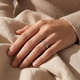 Woman wearing starlets ring, delicate minimalist stacking ring for everyday wear and effortless style
