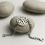 Belle Fever tree bracelet in silver tone displayed on natural stone background. a thoughtful gift for women.