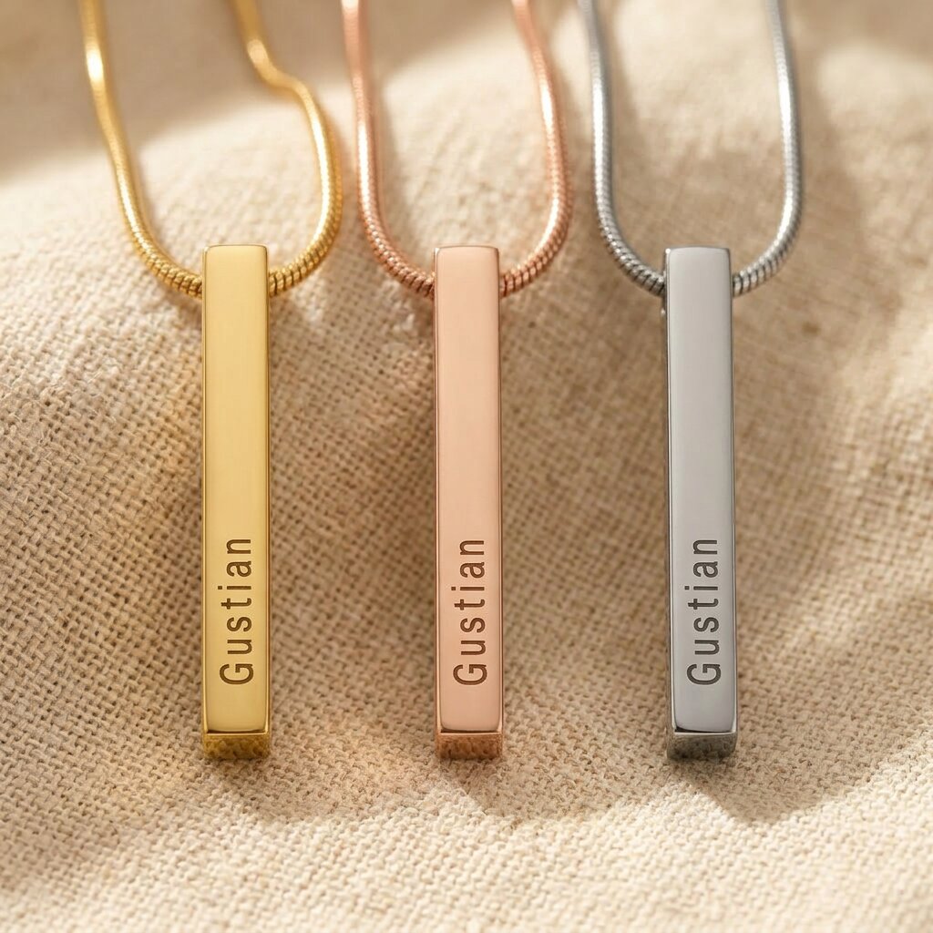 Vertical bar necklace showing different metal finishes with engraved bar pendant design