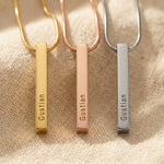 Vertical bar necklace showing different metal finishes with engraved bar pendant design