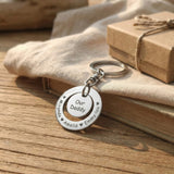Washer Disc Keyring placed on table with engraved disc and charm, personalised keepsake lifestyle image
