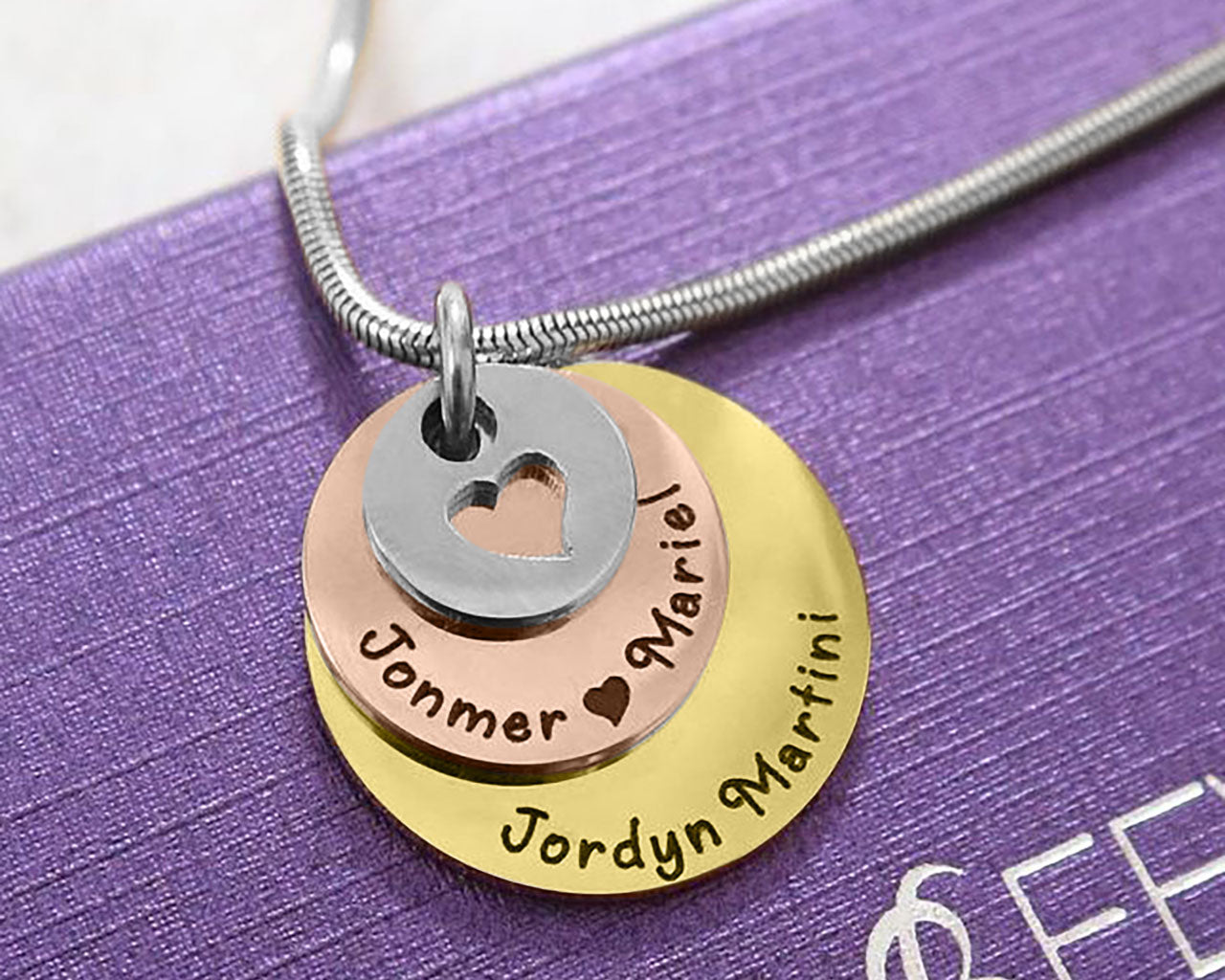 Close-up of the three tone rose gold Tower of Love necklace with layered round charms, design by Belle Fever Jewellery